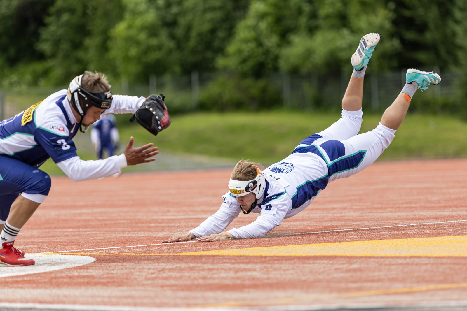 A runner diving for the base